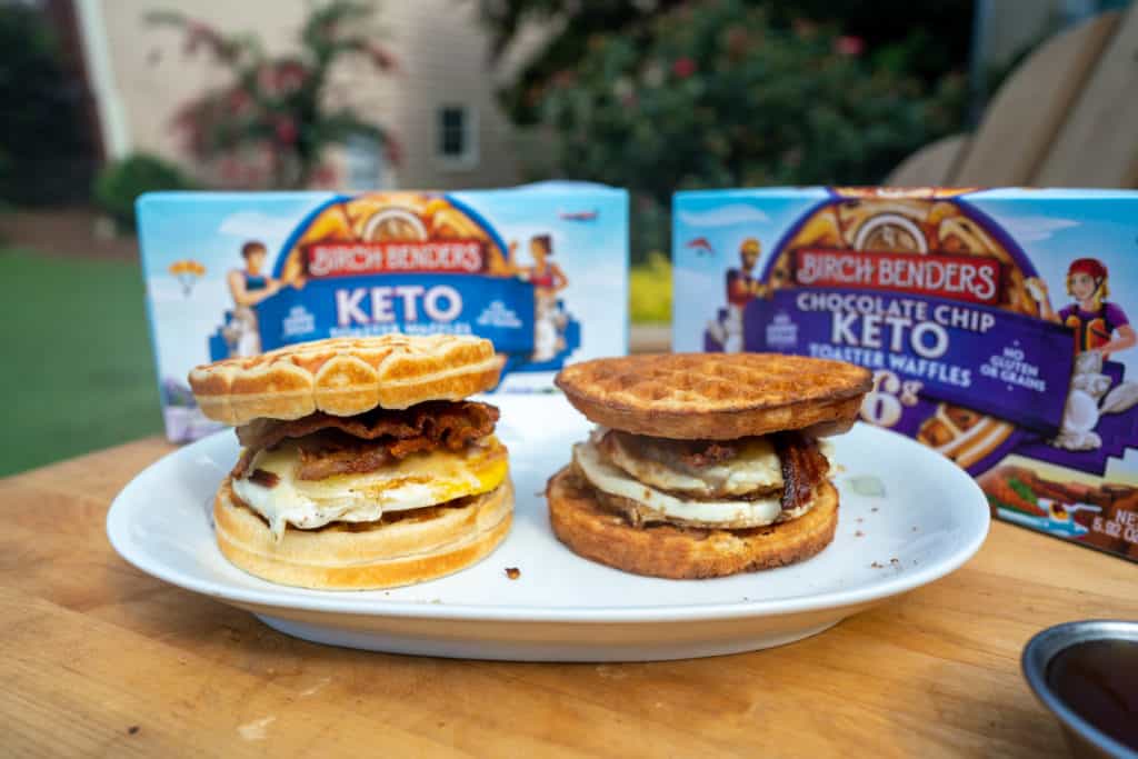 two keto breakfast sandwiches on a plate with maple syrup