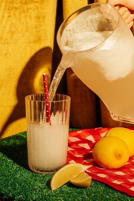 pitcher of lemonade being poured into a glass